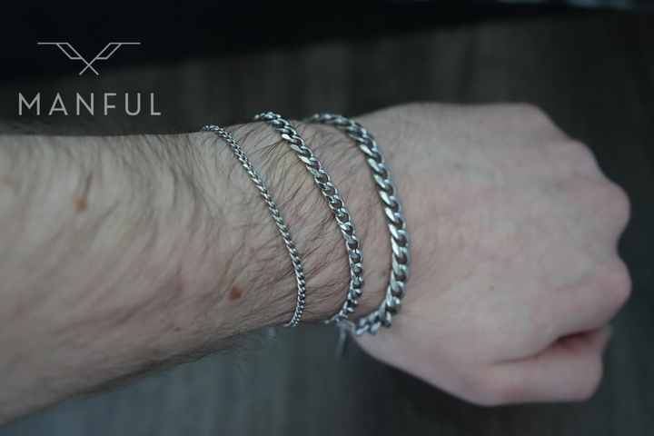 Cuban Chain Bracelet Silver, three widths stacked and worn on a man's wrist