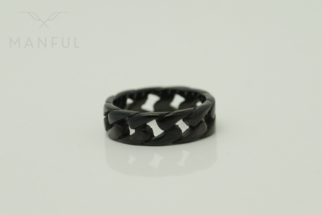 Cuban Chain Ring Black, standing upright on a pale background with a soft reflection