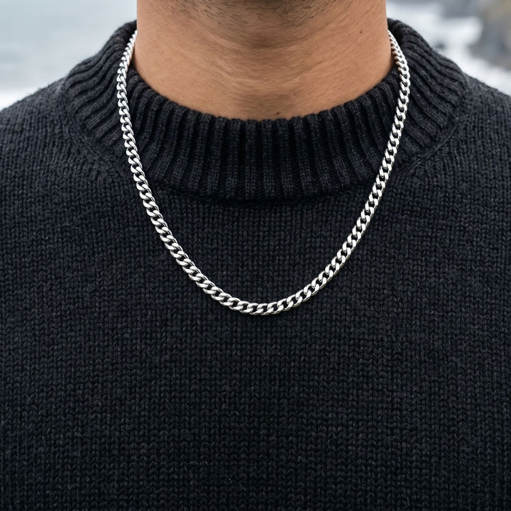 Cuban Chain 5mm Silver worn over a charcoal knit jumper by the sea