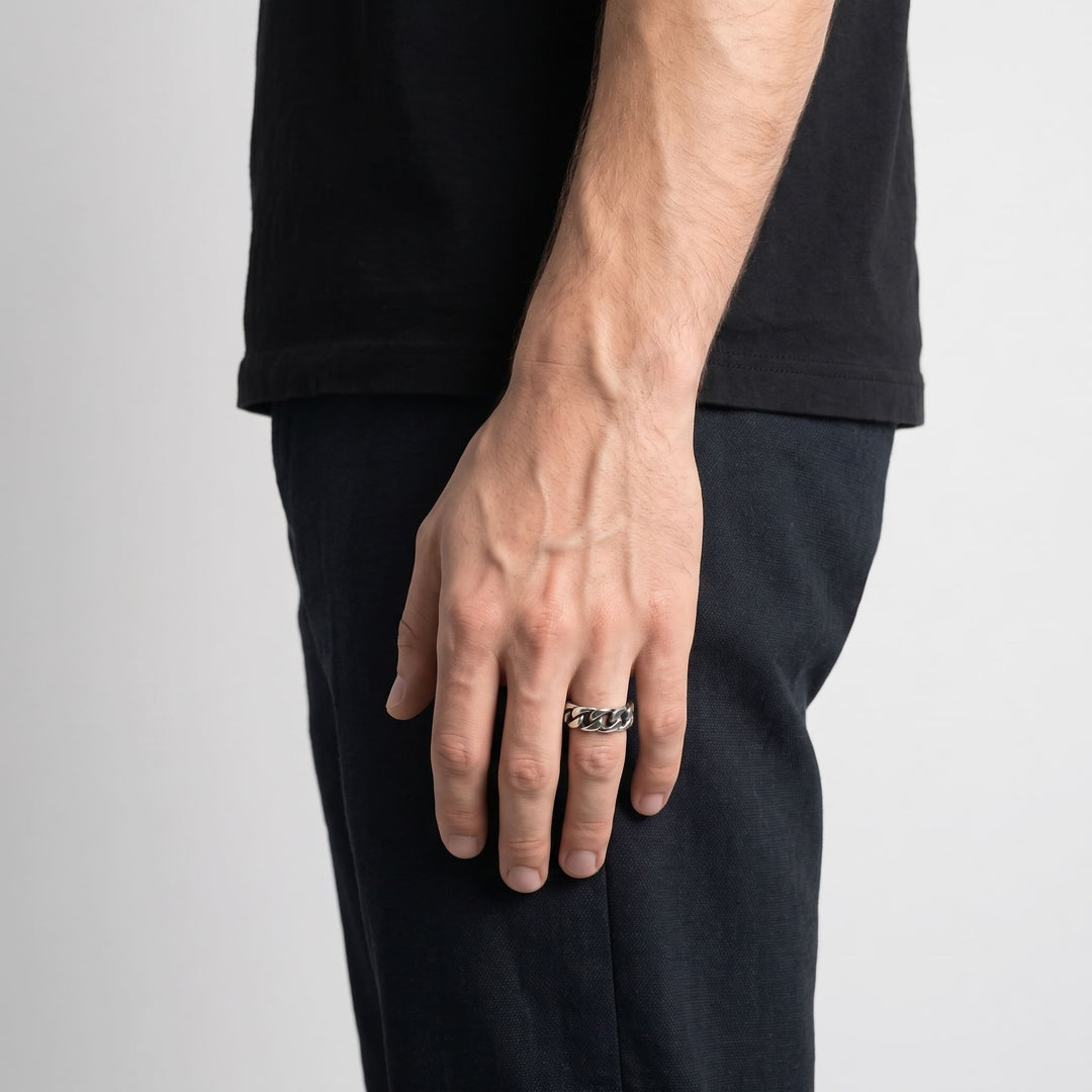 Cuban Chain Ring (Silver) worn on a man's ring finger, his hand relaxed at his side