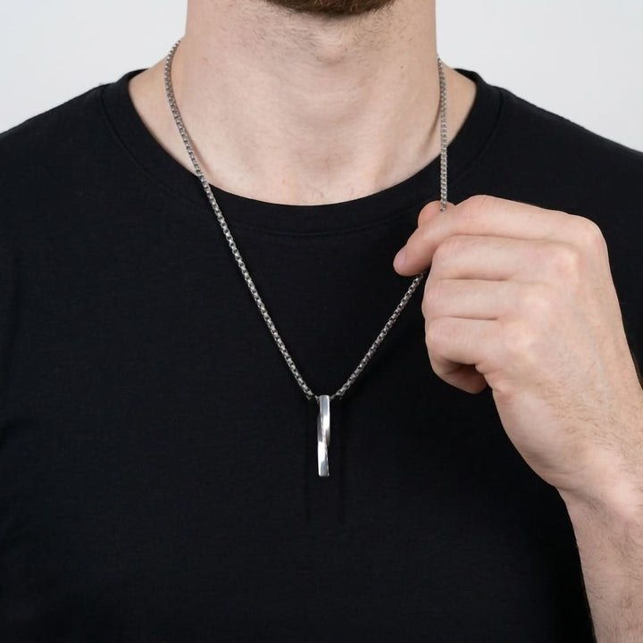 Cuboid Pendant Chain (Silver) on a man's chest as he holds the chain near his collar