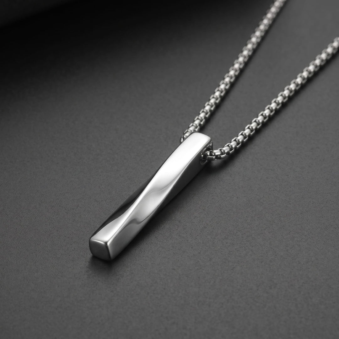 Cuboid Pendant Chain (Silver) lying on a dark charcoal surface