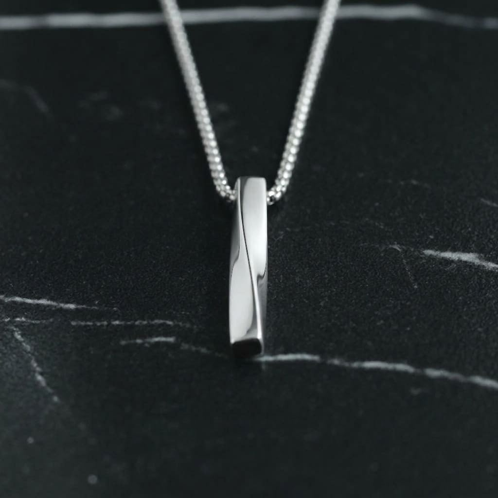 Cuboid Pendant Chain (Silver) lying on black marble