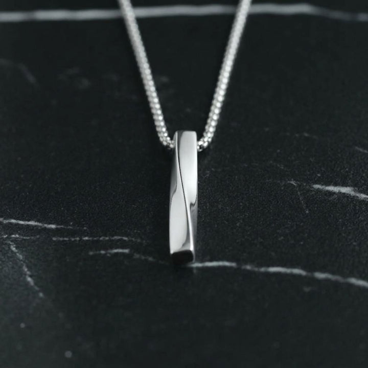 Cuboid Pendant Chain (Silver) lying on black marble