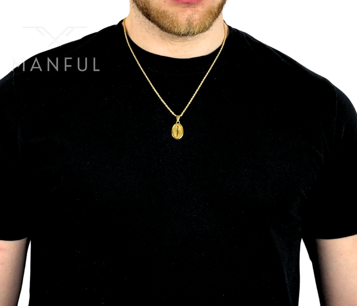 Dagger Emblem Pendant Necklace Gold, worn on a man's neck over a black t-shirt