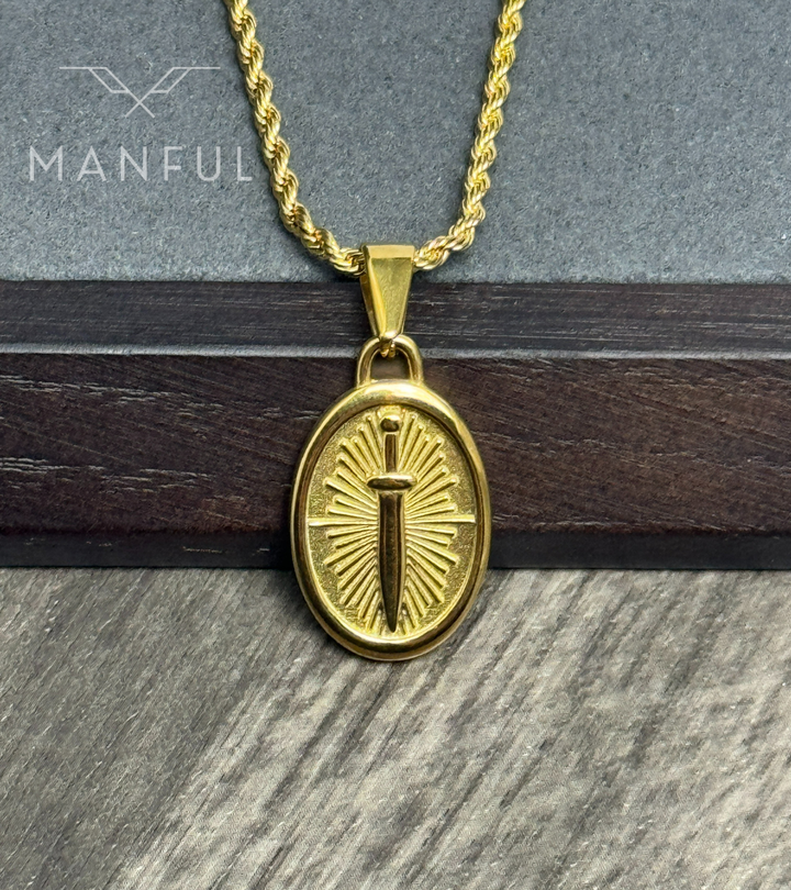 Dagger Emblem Pendant Necklace Gold, draped over a dark wood step at an angle
