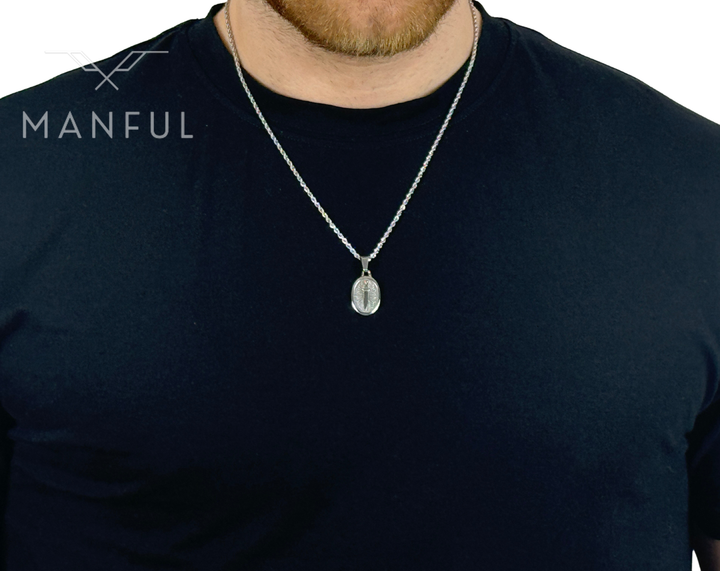 Dagger Emblem Pendant Necklace Silver, worn on a bearded man's neck over a black t-shirt