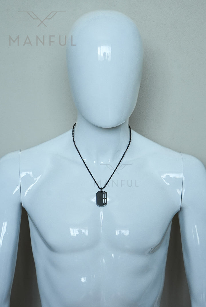 Dog Tag Chain Black, worn around a mannequin's neck resting on the chest