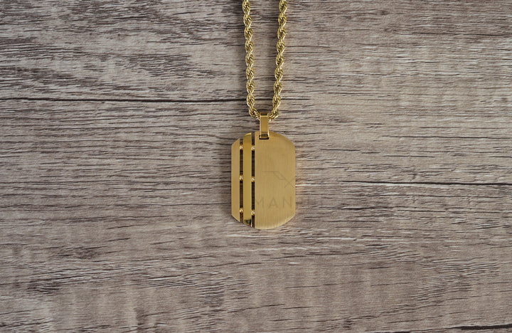 Dog Tag Chain Gold, flat lay viewed from above on a wood grain surface with the chain looped overhead