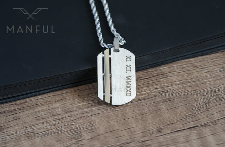 Dog Tag Chain Silver, close-up on wood showing the engraved date on the tag