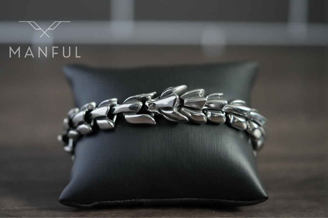 Dragon Link Bracelet Silver, draped over a black leather cushion for a close side view