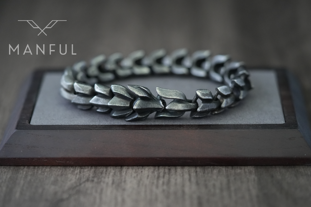 Dragon Link Bracelet Black, lying flat on a wooden display block