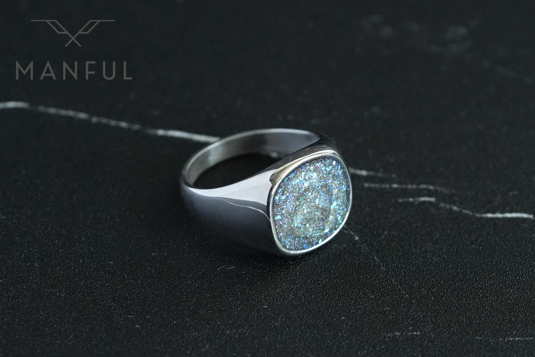 Galaxy Signet Ring, angled on a dark marble surface with white veining