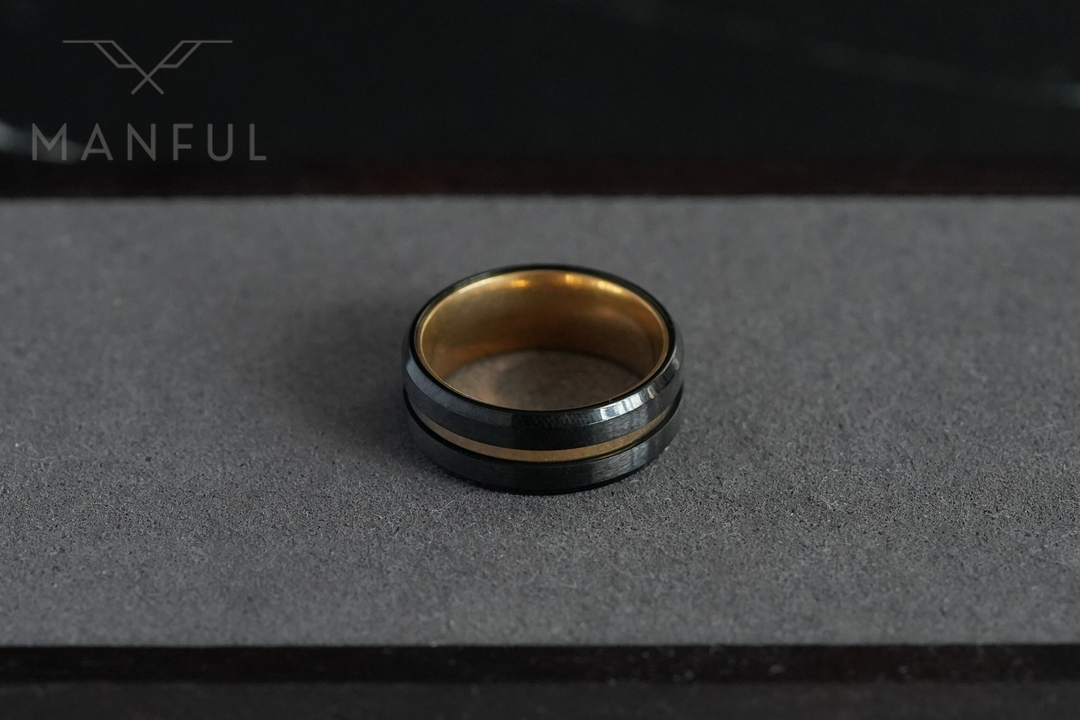 Gold & Black Band, resting on the grey foam lid of its gift box