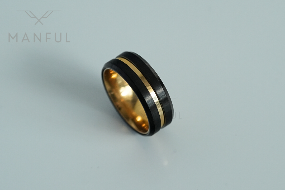 Gold & Black Band, angled on a plain light grey surface
