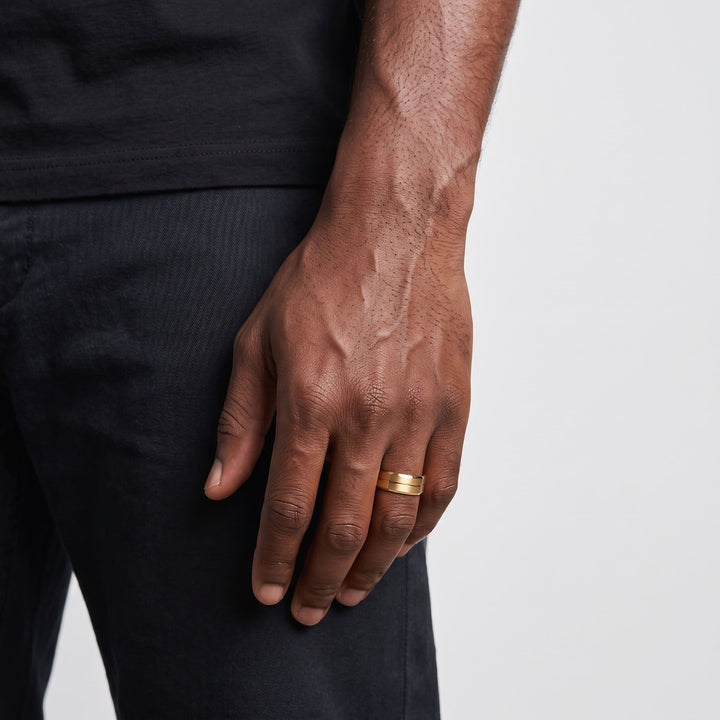 Gold Band on a man's finger, his hand hanging at his side