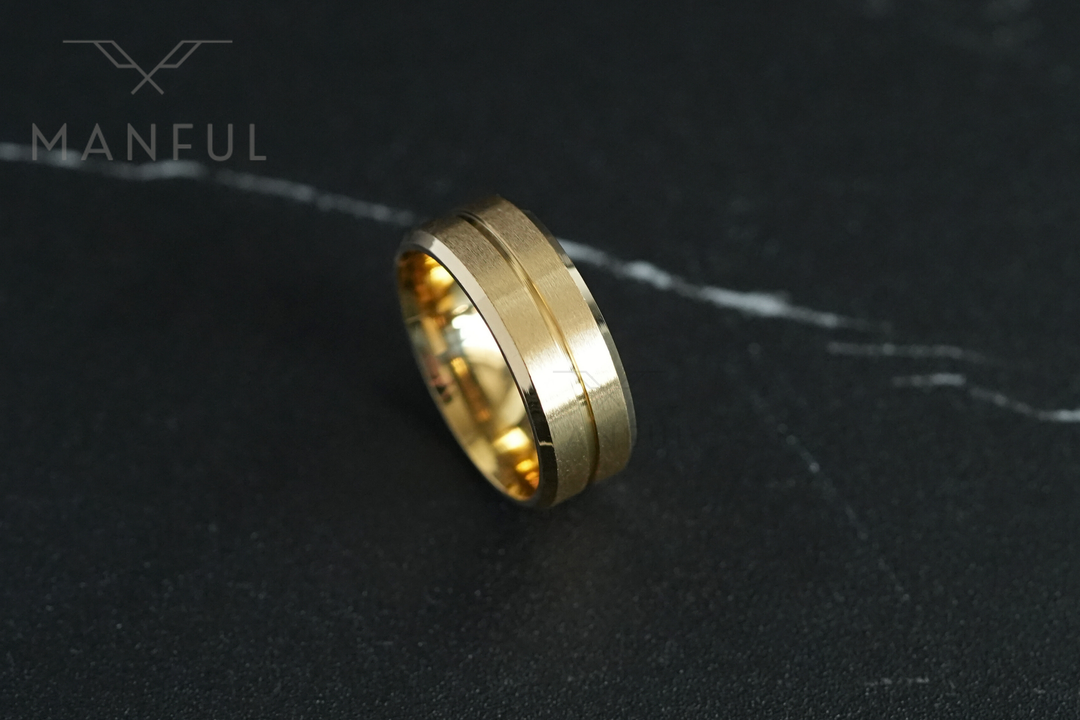 Gold Band, standing upright on a dark marble surface