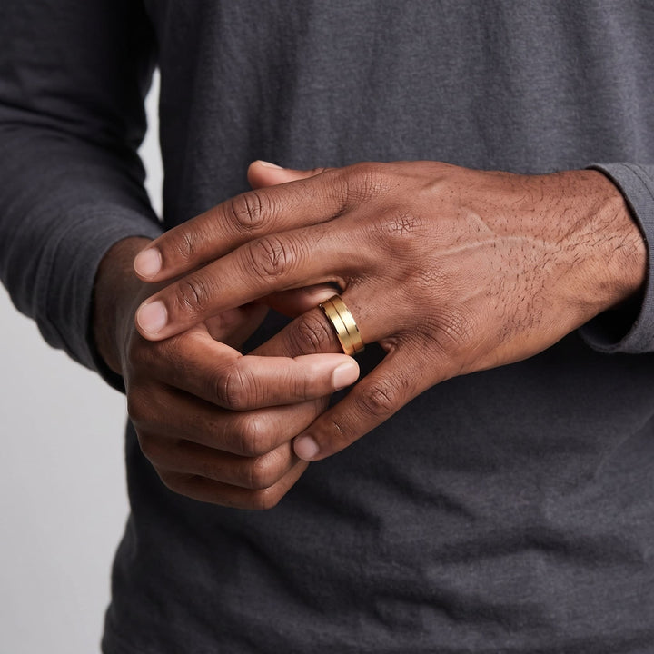 Gold Band on a man's finger as he turns it with his other hand