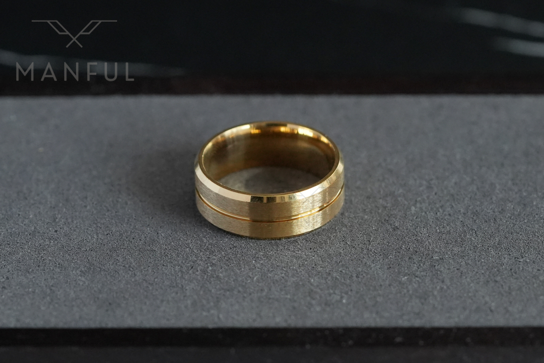 Gold Band, resting on a grey concrete surface near a dark corner