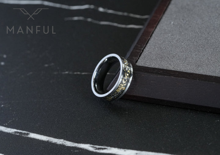 Gold Leaf Inlay Band Silver, propped against the corner of a dark book