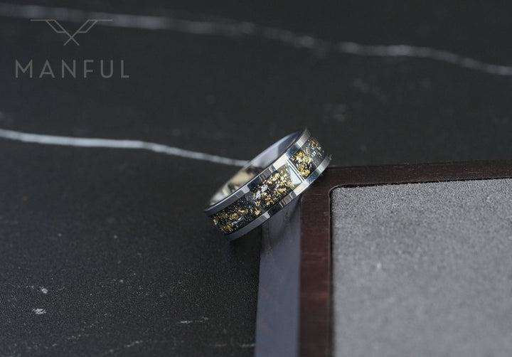 Gold Leaf Inlay Band Silver, balanced on the point of a book's corner