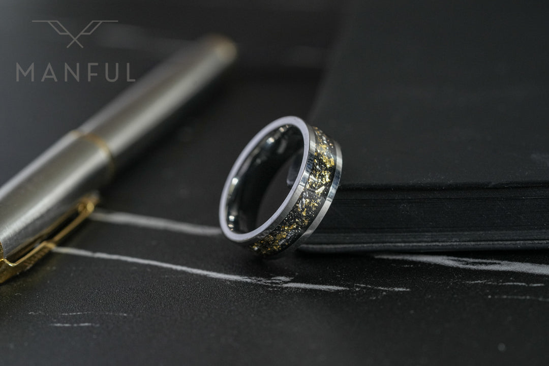 Gold Leaf Inlay Band Silver, resting beside a silver pen on a marble surface