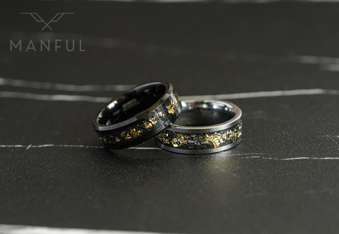 Gold Leaf Inlay Band Silver, paired with a matching black ring on a marble surface