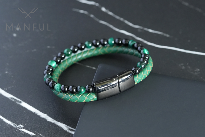 Jade Bead And Leather Bracelet, coiled on a dark marble surface with the gunmetal clasp lower right