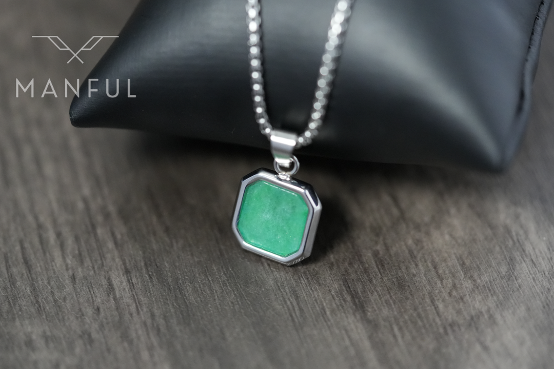 Jade Square Necklace, close-up leaning against a black pouch on a wood surface