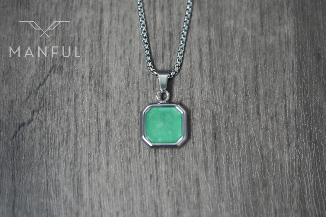 Jade Square Necklace, close-up flat on a wood surface showing the front of the green pendant