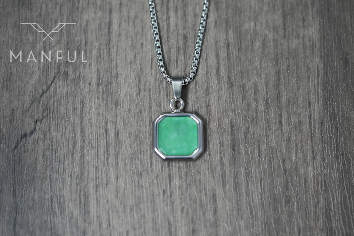 Jade Square Necklace, close-up flat on a wood surface showing the front of the green pendant