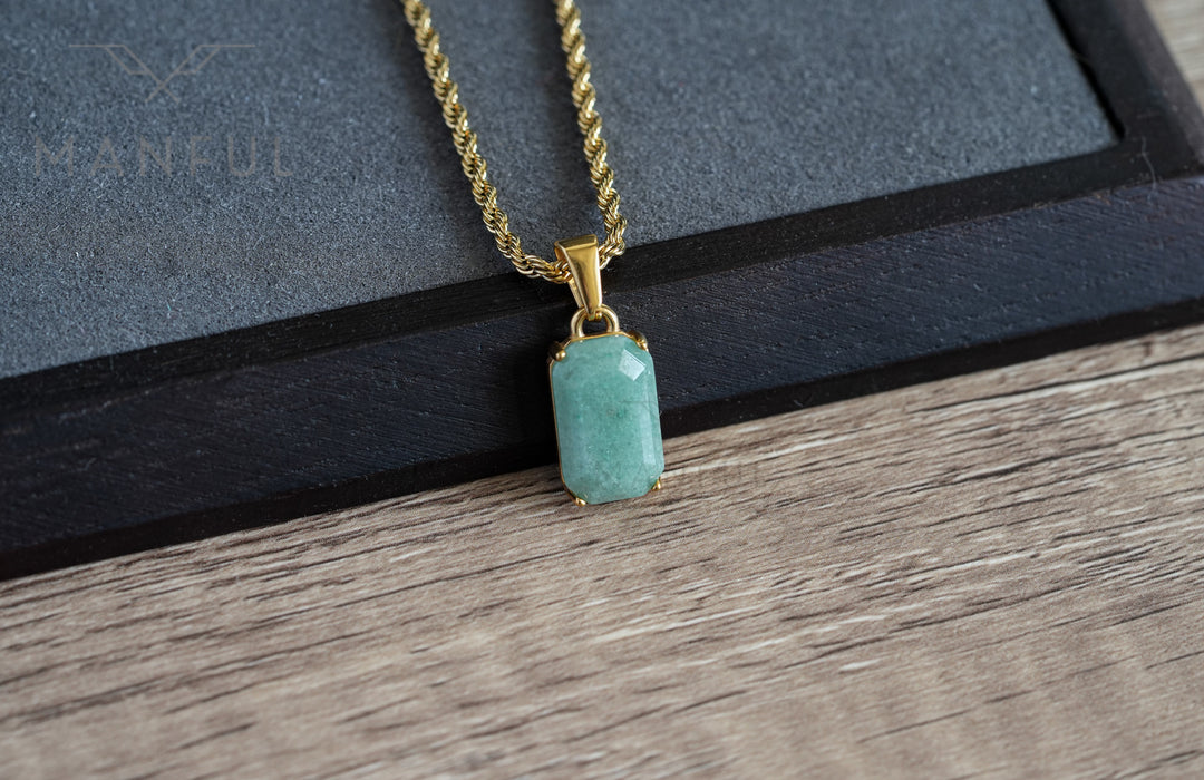 Jade Stone Pendant Gold, resting on a black velvet tray with the chain draped across it