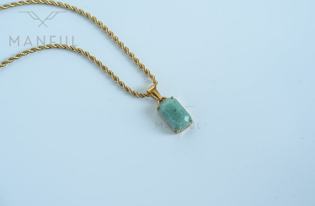 Jade Stone Pendant Gold, close-up on a white background with the chain draped diagonally