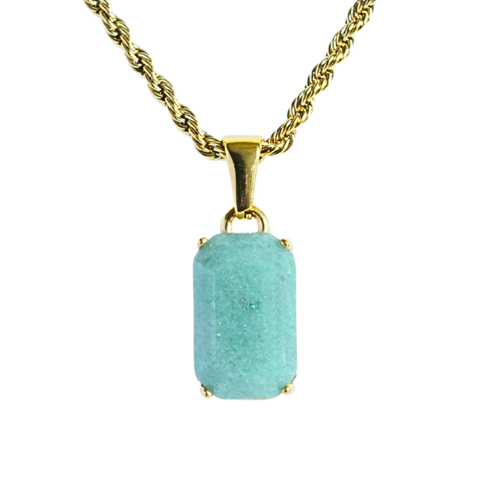 Jade Stone Pendant Gold, isolated on a white background hanging straight down on a rope chain