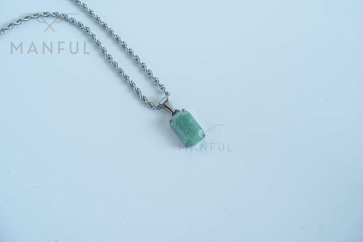 Jade Stone Pendant Silver, isolated on white with the chain draped loosely across a wide background