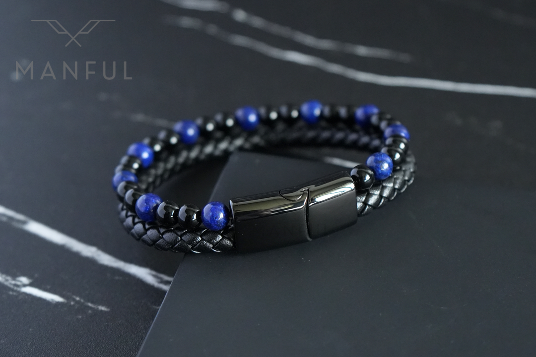 Lapis And Onyx Bead Leather Bracelet, resting on a dark marble surface at an angle showing the double braided strap