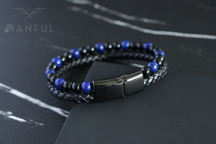 Lapis And Onyx Bead Leather Bracelet, resting on a dark marble surface at an angle showing the double braided strap