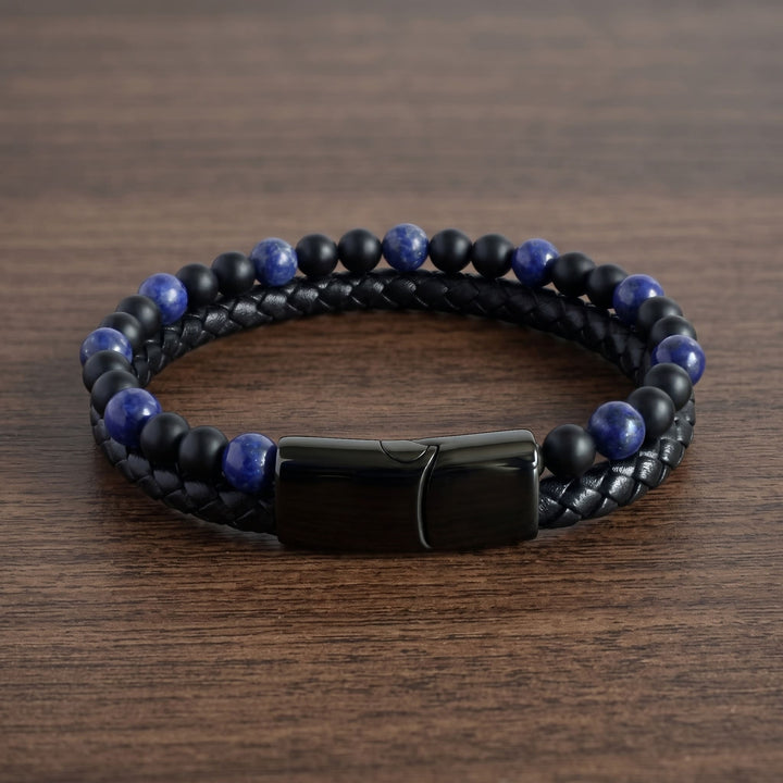 Lapis And Onyx Bead Leather Bracelet on a walnut table with the black clasp at the front