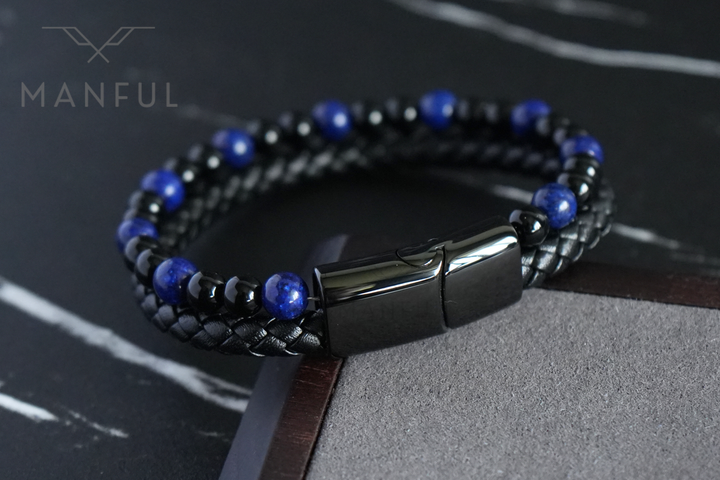 Lapis And Onyx Bead Leather Bracelet, resting on a wooden desk edge with a grey suede backdrop