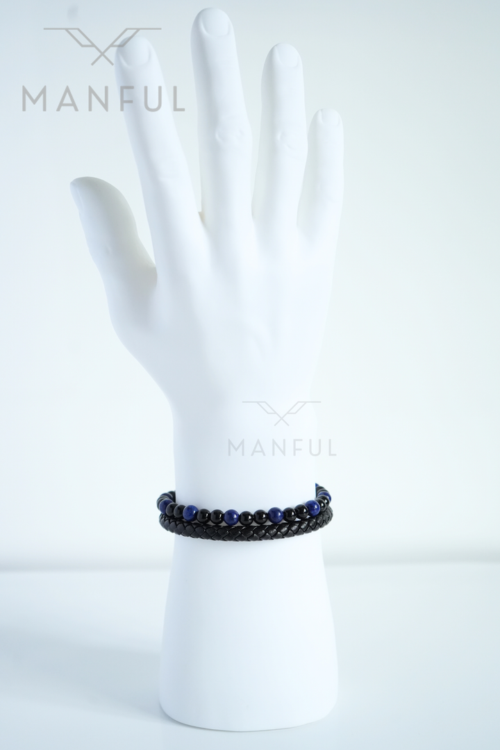 Lapis And Onyx Bead Leather Bracelet, worn on a man's wrist with fingers spread against a white background