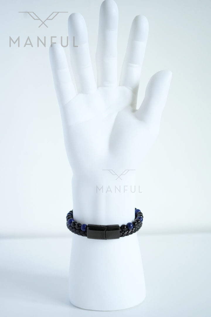 Lapis And Onyx Bead Leather Bracelet, worn on a man's raised wrist in a close crop against white