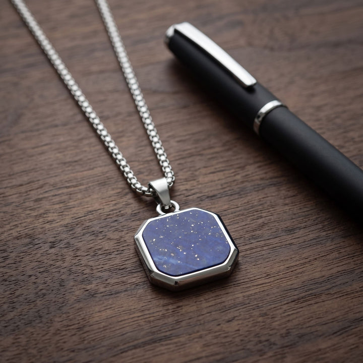 Lapis Square Necklace (Silver) on a walnut desk beside a black pen