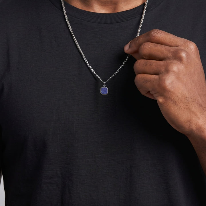 Lapis Square Necklace (Silver) on a man's chest as he holds the chain near his collar
