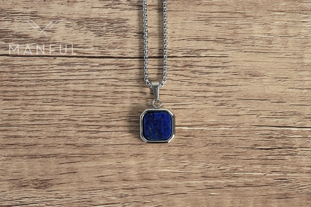 Lapis Square Necklace Silver, lying flat on a wood surface with the blue lapis stone in focus