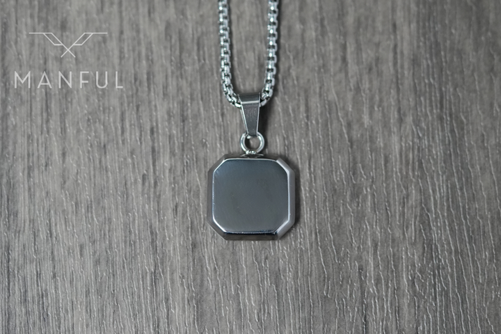 Lapis Square Necklace Silver, lying flat on wood showing the plain silver back of the pendant