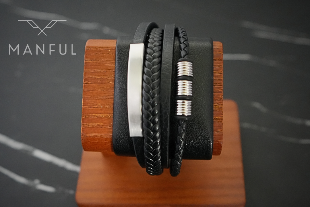 Black & Silver Leather Bracelet, draped over a wooden bracelet display stand