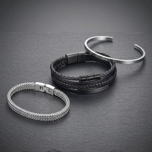 Mens Bracelets Collection, a silver foxtail chain, black braided leather and a silver cuff on dark slate