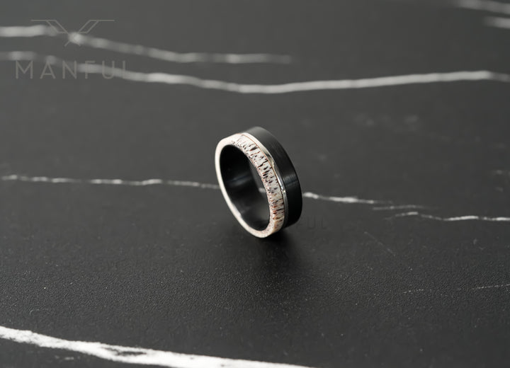 Midnight Antler Band, standing on a dark marble surface at an angle