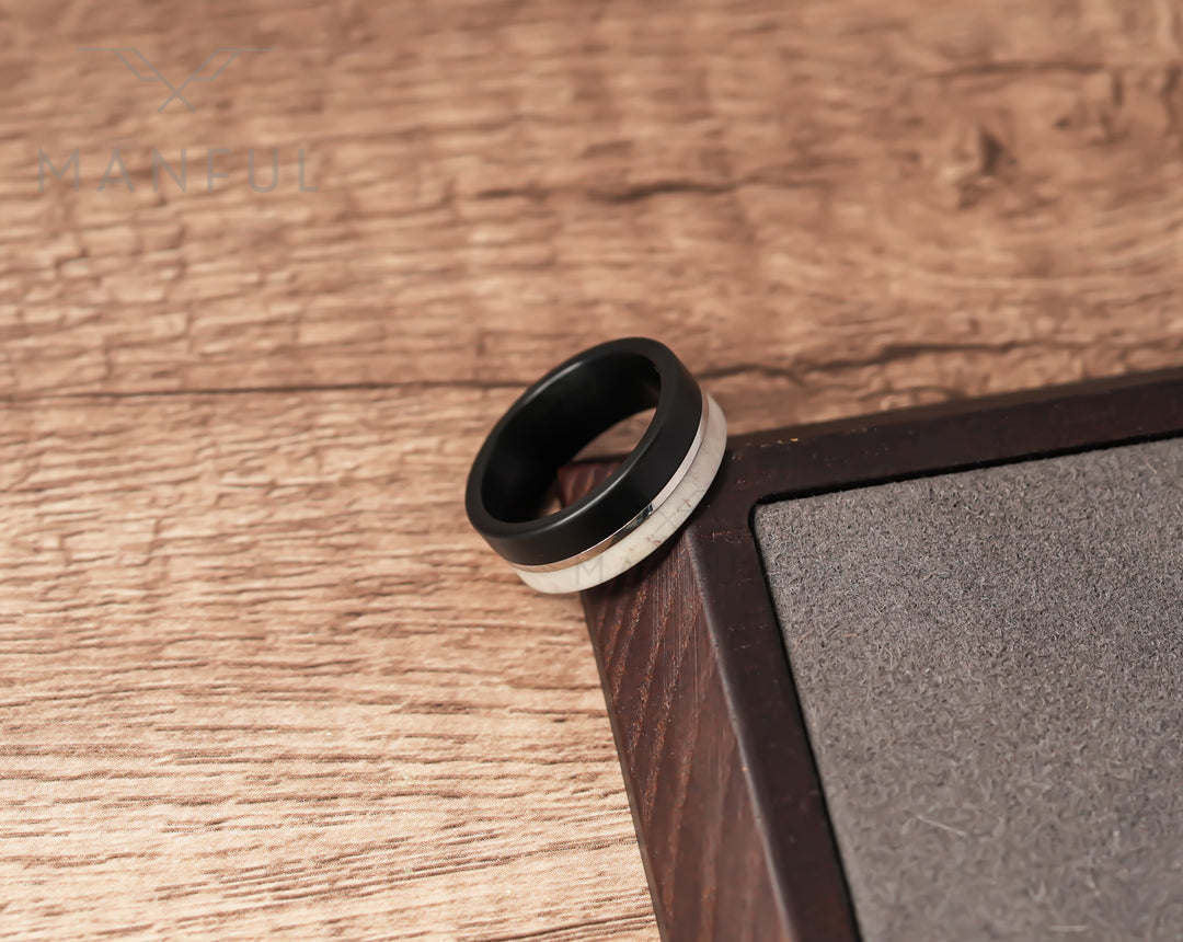 Midnight Antler Band, leaning on the corner of a sand-inlaid wooden tray