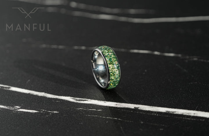 Moss Agate & Crushed Opal Ring, tilted on a dark textured surface with the green inlay facing forward